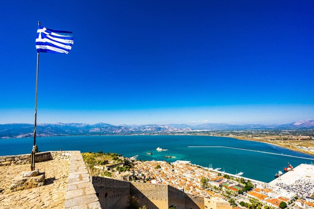 Greek Flag waving on Palamidi Fortress in Nafplion, Argolis - Greece. High quality photo